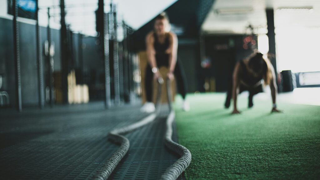 gym members drill training on turf grass inside gym